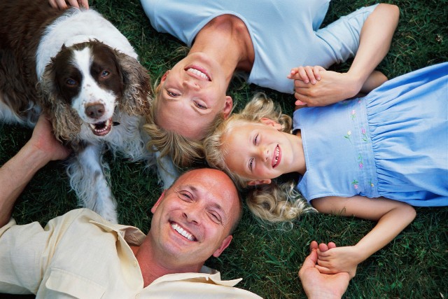 family on the grass with dog