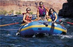 3 people in a rafting boat on river