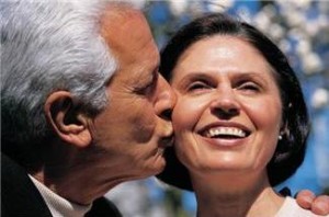 man kissing wife on the cheek