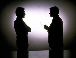 2 men talking in silhouette