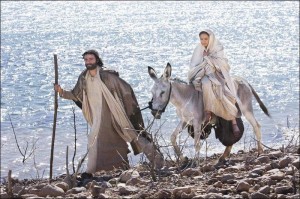 Joseph leading Mary on a donkey