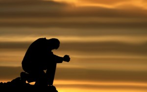man kneeling and praying