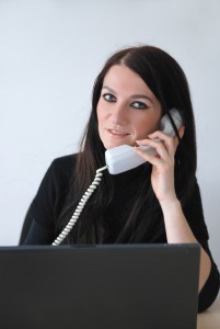 young woman with laptop talking on phone